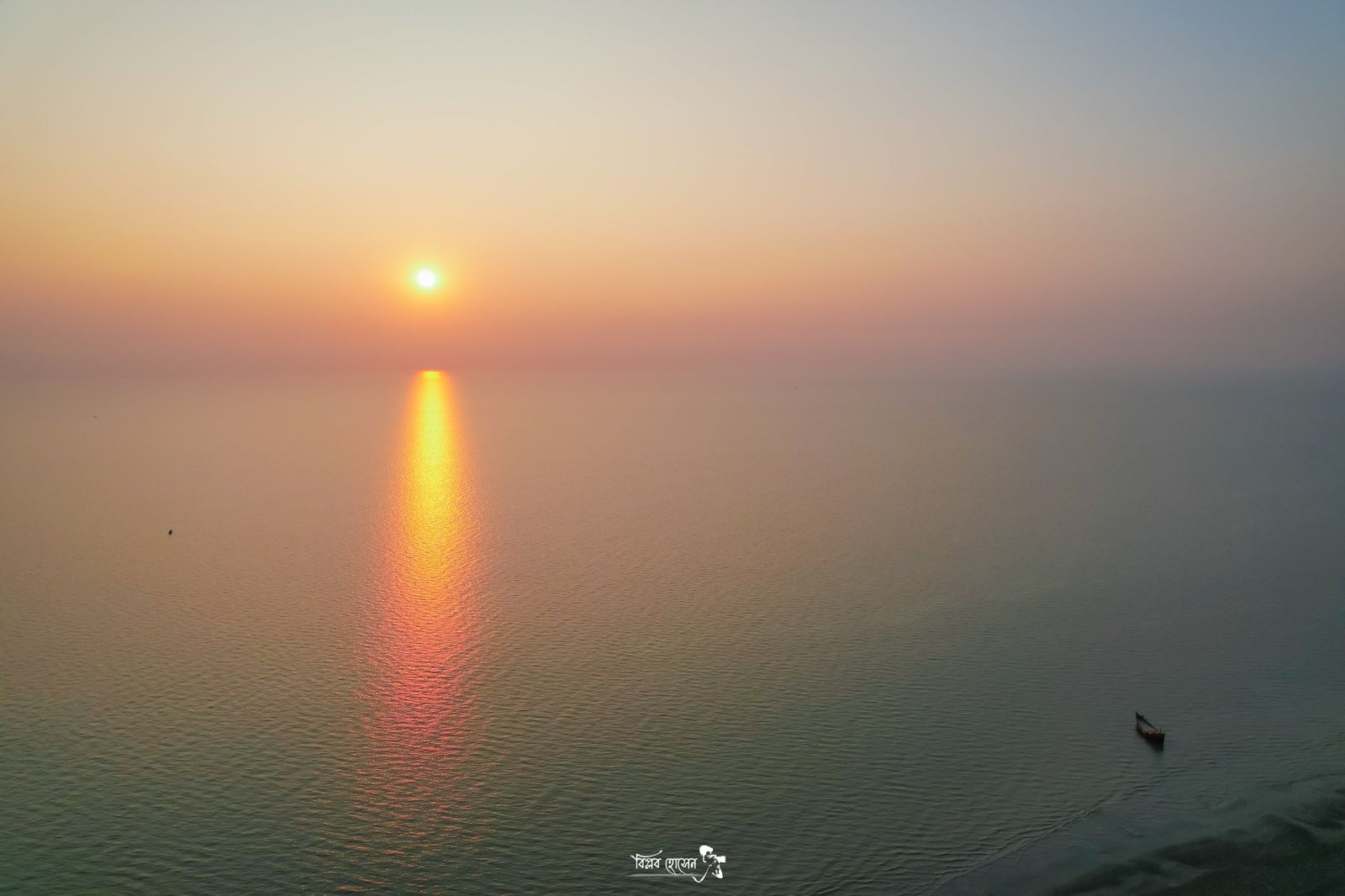 Sun setting over calm water